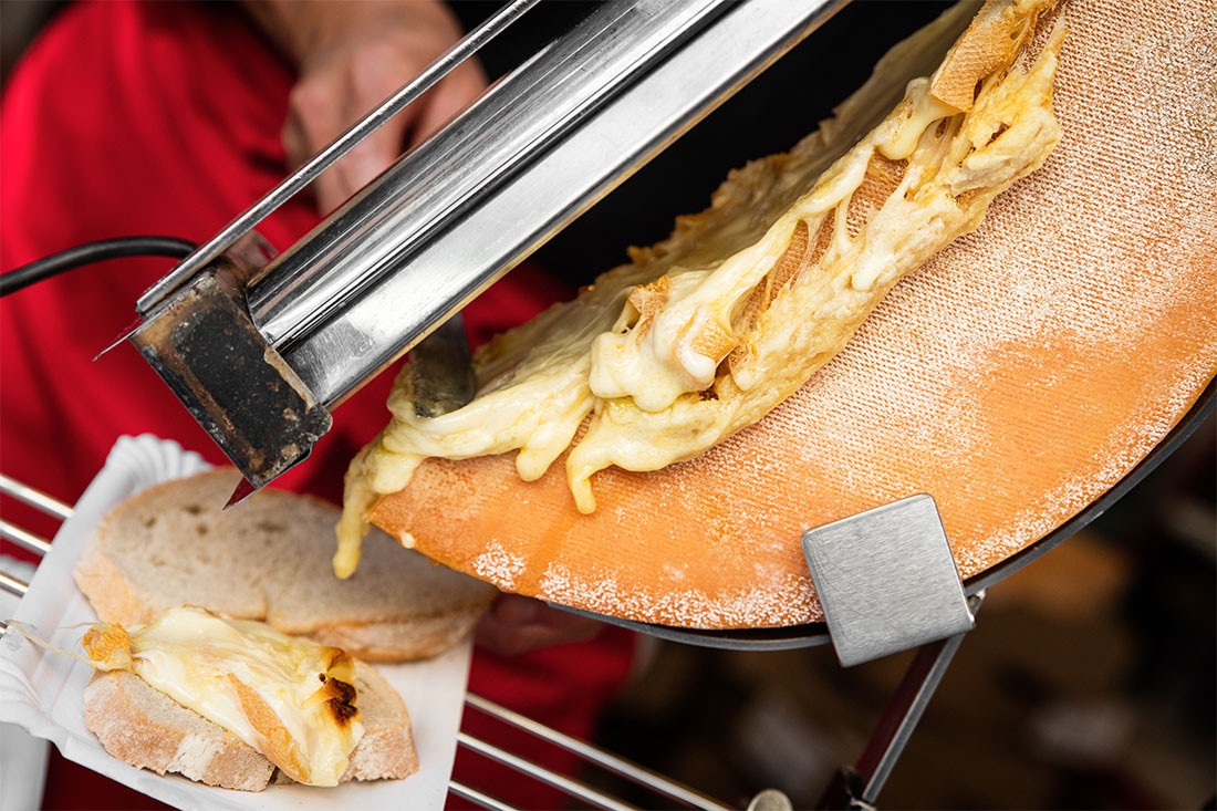 Melted raclette scraped from the wheel